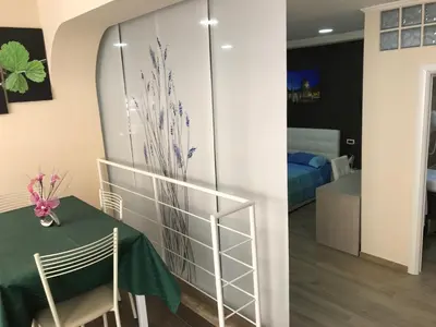 a room with a table and a room with a bedroom at Villa Matissa Apartments in Rome