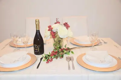 a table with plates and a bottle of wine at Terrazza San Giovanni apartment in Rome