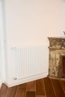 a radiator on a wall next to a wooden floor at Terrazza San Giovanni apartment in Rome