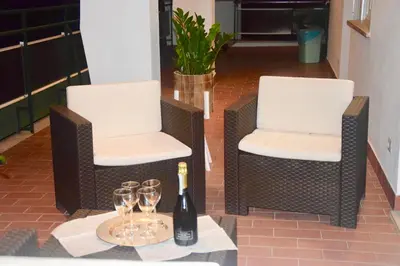 two chairs and a bottle of wine on a table at Terrazza San Giovanni apartment in Rome