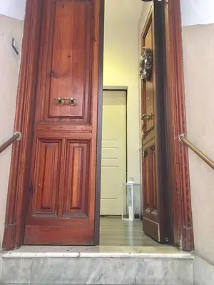 an open wooden door leading to a hallway at Luxy Vatican Apartment in Rome