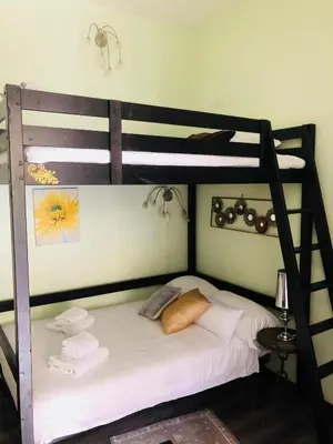a bedroom with two bunk beds with white sheets at Luxy Vatican Apartment in Rome
