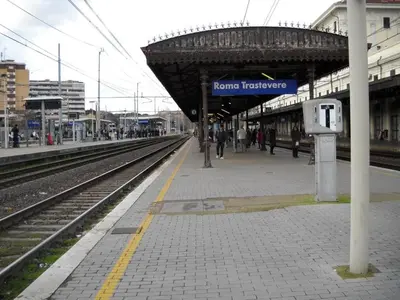 a train station with a sign that reads former hostage at A casa di Armando in Rome