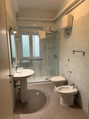 a bathroom with a toilet and a sink and a shower at A casa di Armando in Rome