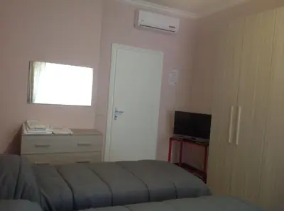 a bedroom with a bed and a television and a window at A casa di Armando in Rome