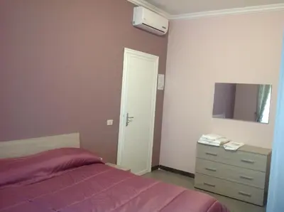 a bedroom with a bed and a dresser and a mirror at A casa di Armando in Rome
