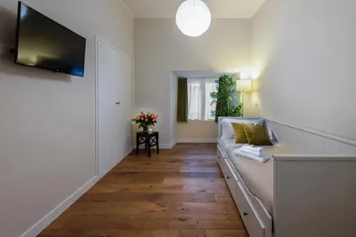 a living room with a couch and a flat screen tv at Tula Inn in Rome