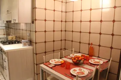 a small kitchen with a table with plates of fruit on it at Affittacamere Nansen in Rome