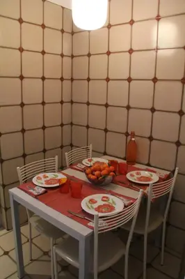 a table with plates of food and a bowl of fruit at Affittacamere Nansen in Rome