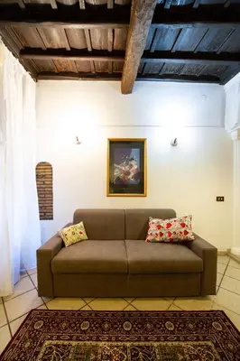 a living room with a brown couch in a room at JUSTACASA alla SCALA Trastevere in Rome