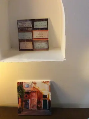 a book sitting on a shelf in a wall at JUSTACASA alla SCALA Trastevere in Rome