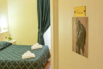 a bedroom with a bed with two towels on it at Annette B&B in Rome
