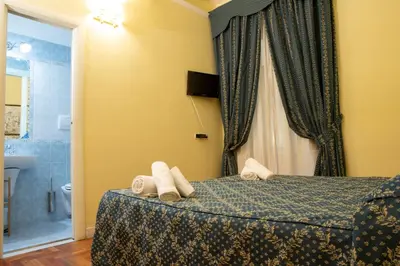 a hotel room with a bed with towels on it at Annette B&B in Rome