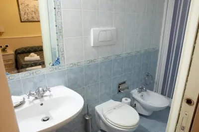 a bathroom with a white toilet and a sink at Annette B&B in Rome