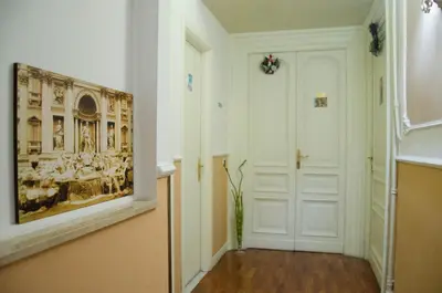 a hallway with a painting on the wall and a door at Annette B&B in Rome