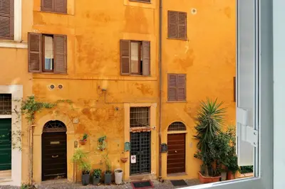 an orange building with brown doors and windows at Clementina Charme - My Extra Home in Rome