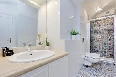 a white bathroom with a sink and a toilet at Clementina Charme - My Extra Home in Rome