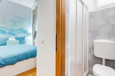 a small bathroom with a bed and a toilet at BDC - Opera Studio in Rome