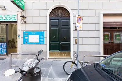 a scooter parked in front of a building with a green door at BDC - Opera Studio in Rome