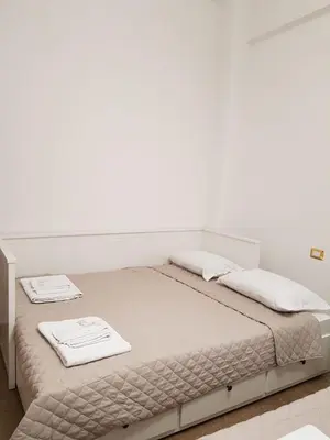 a white bed with two white towels on it at INTERNO DIECI in Rome