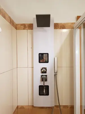 a shower in a bathroom with a tv on the wall at INTERNO DIECI in Rome