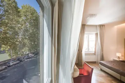 a room with a large window with a view of a city at Rome River Inn in Rome