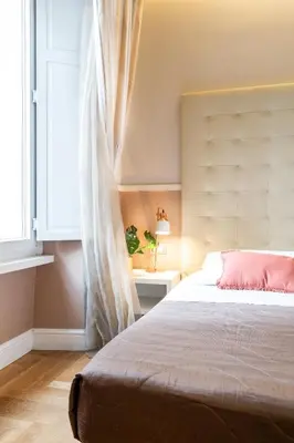 a bedroom with a large bed and a window at Rome River Inn in Rome