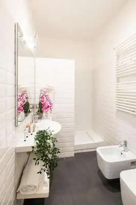 a white bathroom with two sinks and a bath tub at Rome River Inn in Rome