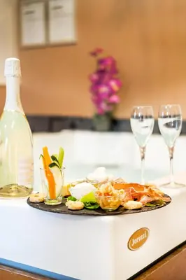 a plate of food and two wine glasses on a counter at Rome River Inn in Rome