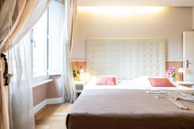 a bedroom with a large bed with pink pillows at Rome River Inn in Rome