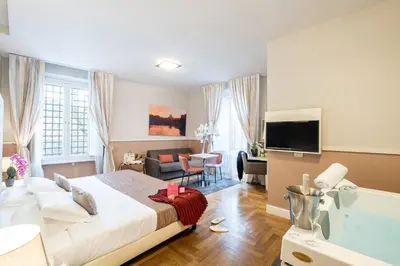 a bedroom with a large bed and a living room at Rome River Inn in Rome