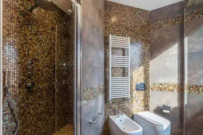 a bathroom with a shower and a sink and a toilet at 900 Apartments Veneto & Pinciana in Rome