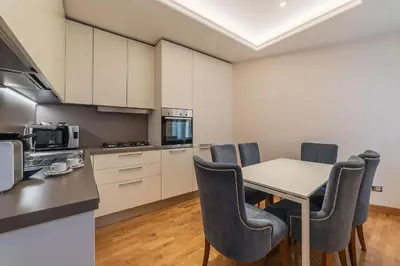 a kitchen and dining room with a table and chairs at 900 Apartments Veneto & Pinciana in Rome
