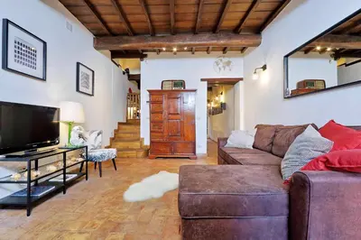 a living room with a couch and a tv at San Callisto in Rome