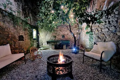 a fire pit in a room with a stone wall at San Callisto in Rome
