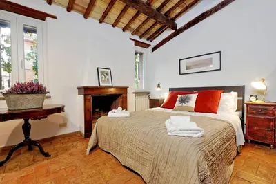 a bedroom with a large bed with towels on it at San Callisto in Rome