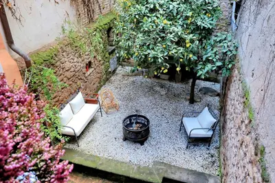 a backyard with two chairs and a fire pit at San Callisto in Rome