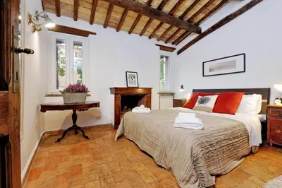 a bedroom with a large bed and a table at San Callisto in Rome