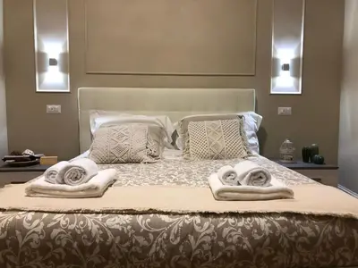 a bedroom with a bed with towels on it at Pantheon Luxury Suite in Rome