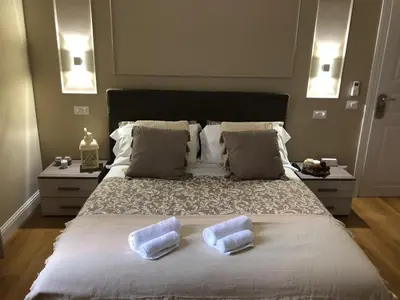 a bedroom with a large bed with two pillows on it at Pantheon Luxury Suite in Rome
