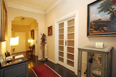 a living room with a painting on the wall at Amica Roma Guest House in Rome