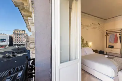 a room with a bed and a window at Tritone 125 Suite in Rome