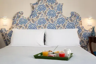 a tray of food sitting on top of a bed at Tritone 125 Suite in Rome