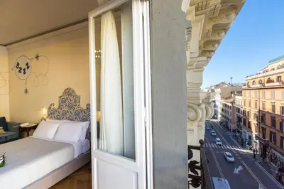 a bedroom with a bed and a view of a city at Tritone 125 Suite in Rome
