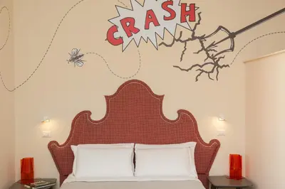 a bedroom with a bed and a sign that reads crash at Tritone 125 Suite in Rome