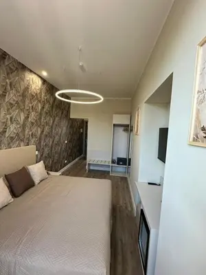 a bedroom with a bed and a wall at TrevInn Suites in Rome