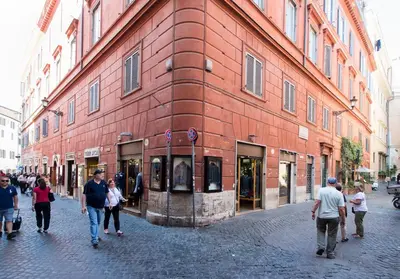 a group of people walking in front of a building at TrevInn Suites in Rome