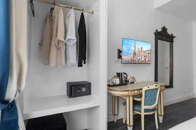a dressing room with a table and a mirror at GHR Navona Inn in Rome