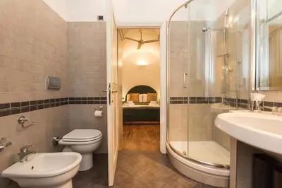 a bathroom with a toilet and a sink and a shower at Lovely New Home, Via Nazionale in Rome
