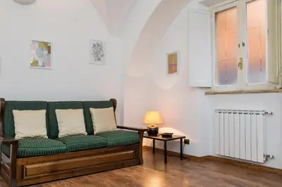 a living room with a green couch and a table at Lovely New Home, Via Nazionale in Rome